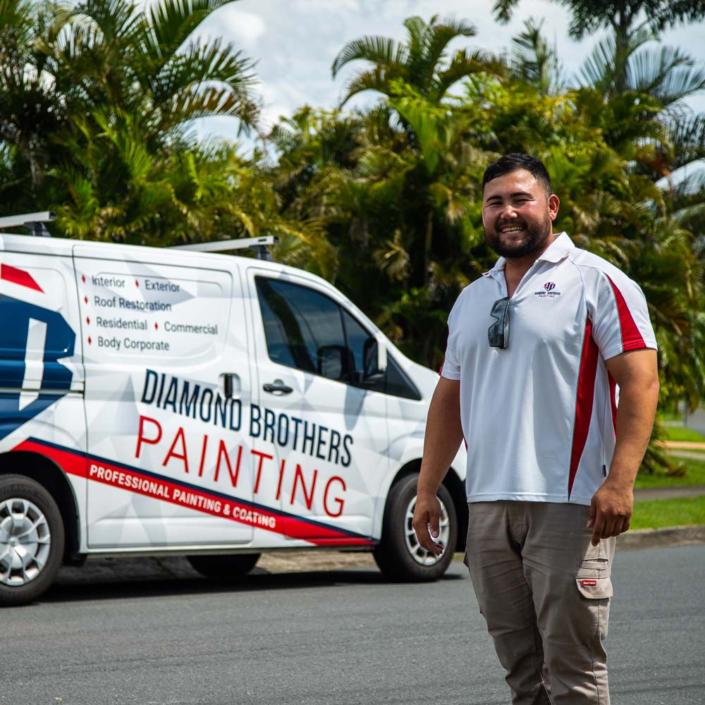 Photo of Danny standing and smiling in front of a work van | featured image for Contact Us.