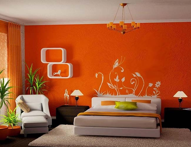 Bedroom with white chair and bed and bright orange wall | featured image for Services.