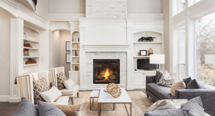 Modern luxurious living room with a fireplace | featured image for What Is Luxury Painting?