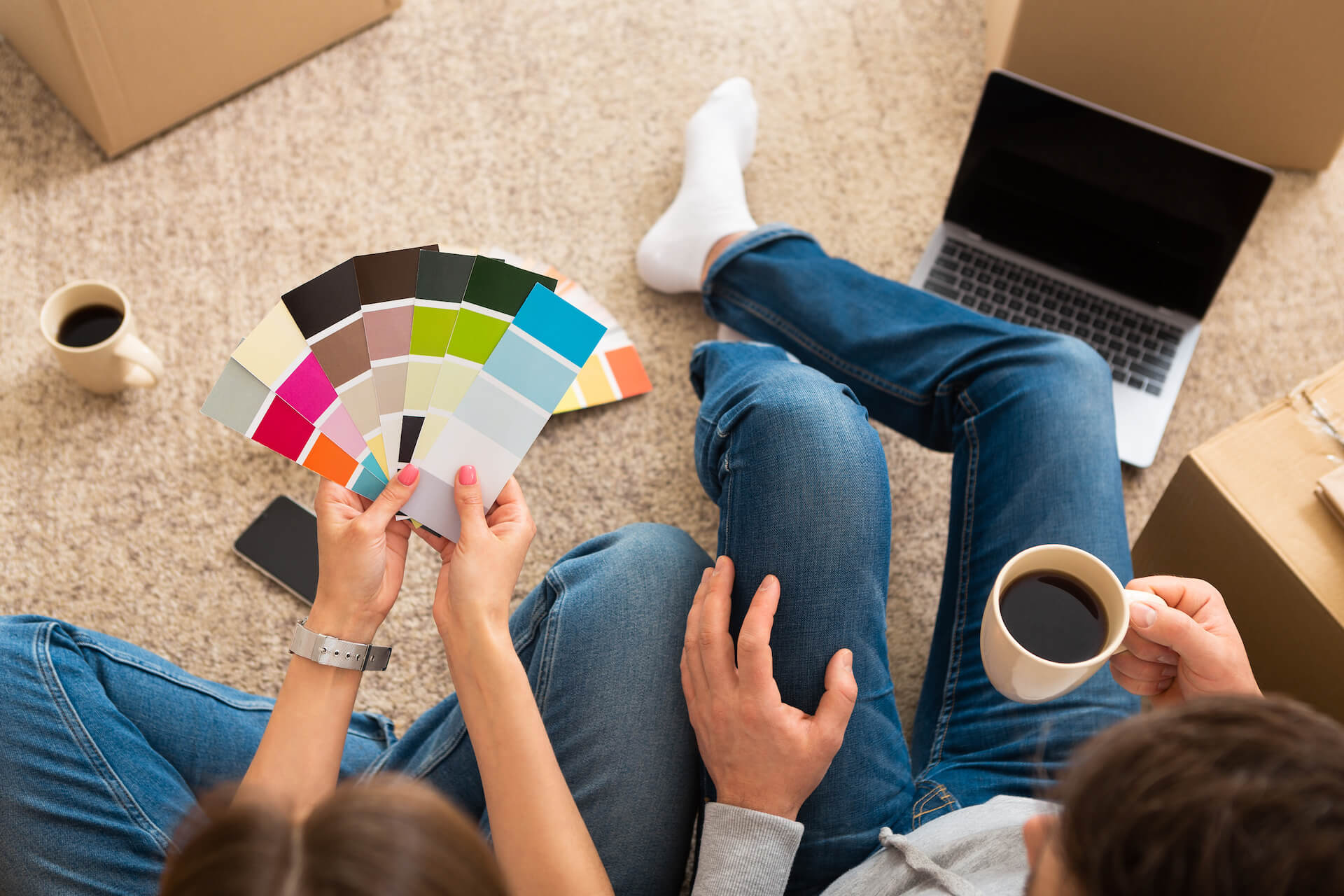 Couple selecting paint colours for their new house | Featured image for How to Choose Paint Colours for Your House blog.